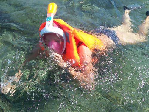 a person in the water wearing a life jacket and a life vest at Tammoyo Place in Kudat