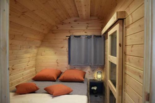 une chambre avec deux lits dans une cabane en bois dans l'établissement A Chjusella di E Sertine, à Tralonca