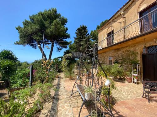 a patio with chairs and plants in front of a building at B&B Villa San Marco in Agrigento