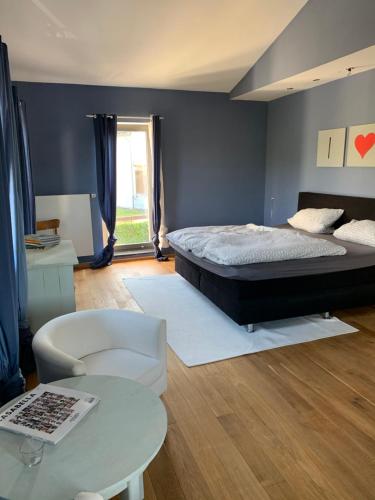 a bedroom with a bed and a table at Design Appartment with big Terrace in Halsenbach