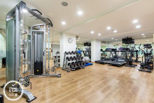 a gym with lots of treadmills and machines at Dom Jose Beach Hotel (Plus) in Quarteira