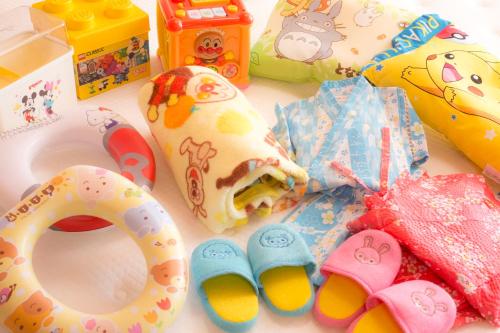 a table topped with toys and a donut and shoes at Dotonbori Hotel in Osaka