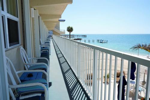 a balcony of a hotel with chairs and the beach at Glunz Ocean Beach Hotel and Resort in Marathon