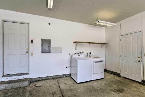 a kitchen with a refrigerator and a white wall at Vallejo Home with Spacious Deck, Hot Tub and Views in Vallejo