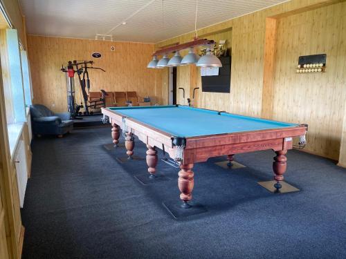 a room with a pool table in a gym at Samana in Tytuvėnai