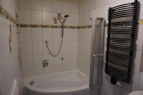 a bathroom with a shower and a bath tub at Ferienwohnung in der Rhön in Willmars