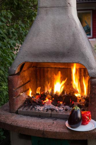 a brick oven with a plate of food next to it at AppartChalet LA RONDULA - 100m from Seceda in Ortisei
