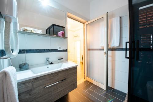 a bathroom with a sink and a shower at Hotel Loredano in Shkodër