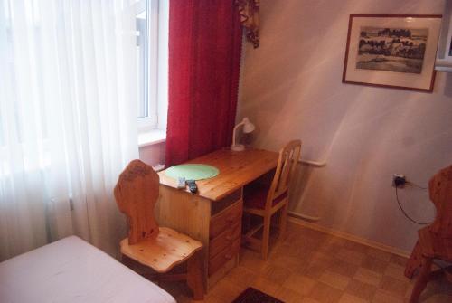 a desk in a room with a window and a table at Eha Suija Home Accommodation in Tartu