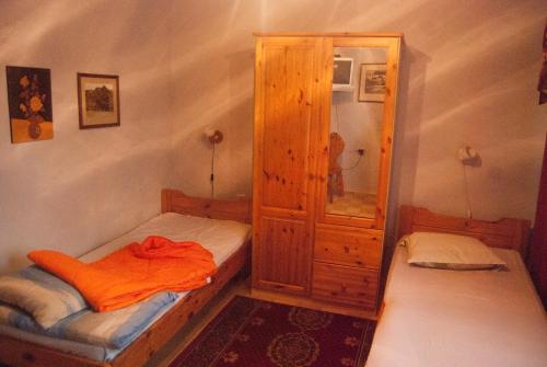 a small room with a bed and a cabinet at Eha Suija Home Accommodation in Tartu