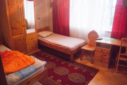 a small bedroom with a bed and a desk and a desk at Eha Suija Home Accommodation in Tartu