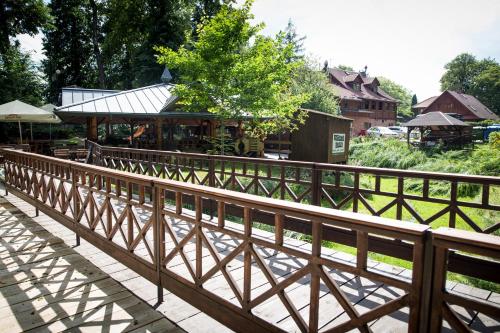 a wooden fence in front of a building at Karczma Regionalna Młyn -pokoje gościne in Zwierzyniec