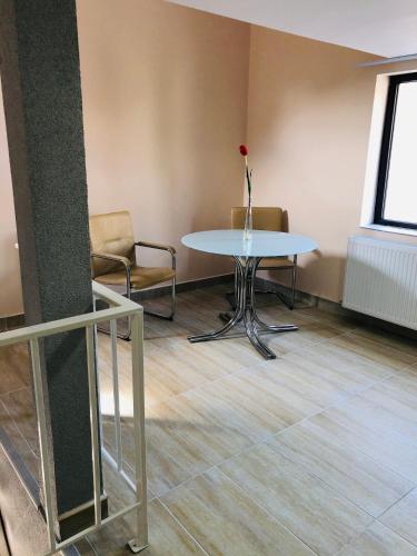 a table in a room with a vase with a rose on it at Carla Maria S Hause in Gammertingen