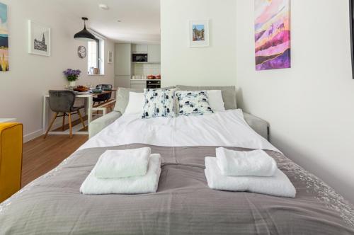 a bedroom with a large bed with two pillows on it at Castle View Luxury 1 Bed Apartment in Edinburgh