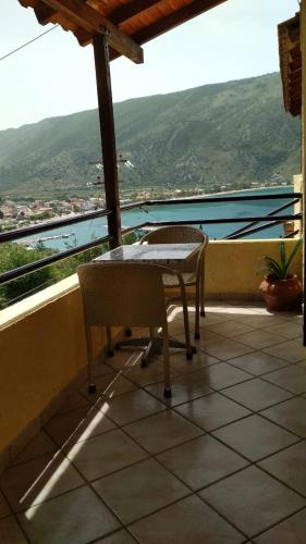 a table and chairs on a balcony with a view at Amazing view apartment in Plataria
