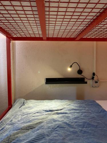 a bedroom with a bed and a light on the ceiling at Orange Village Hostel in San Francisco