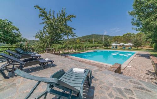 a row of lawn chairs next to a swimming pool at Borgo Nuovo San Martino in Ambra