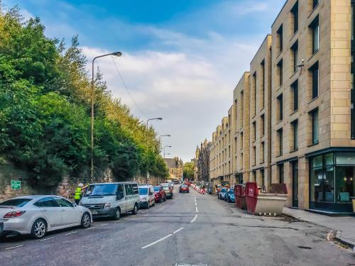 a street with cars parked on the side of the road at Castle View Luxury 1 Bed Apartment in Edinburgh