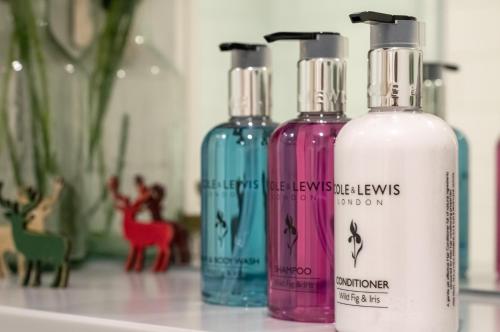 a group of three bottles sitting on a counter at Castle View Luxury 1 Bed Apartment in Edinburgh