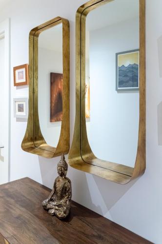 a statue sitting on a table in front of two mirrors at Castle View Luxury 1 Bed Apartment in Edinburgh
