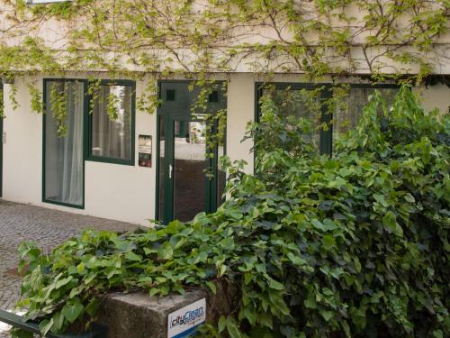 a building with a bunch of green plants in front of it at Nikolai Homes in Vienna