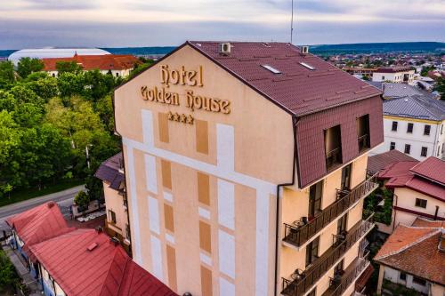 a building with a sign on the side of it at Hotel Golden House in Craiova