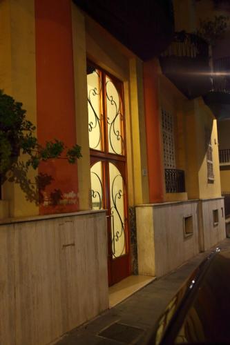 a building with a red door on a street at Materdays 24 in Naples