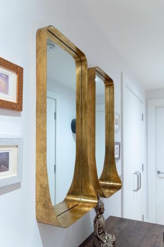 a brass mirror on top of a table at Castle View Luxury 1 Bed Apartment in Edinburgh