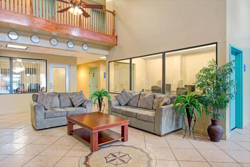 a living room with two couches and a coffee table at Days Inn by Wyndham Downtown St. Louis in Saint Louis