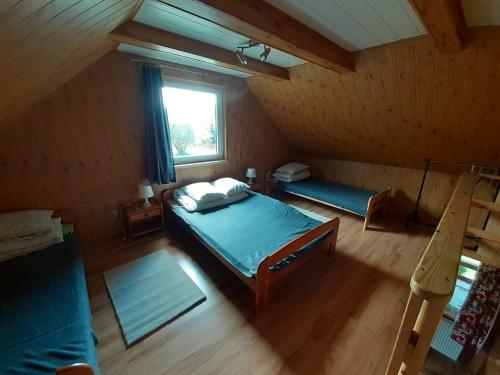 an overhead view of a bedroom with a bed and a window at Siedlisko Bieszczadzkie 3 in Lutowiska