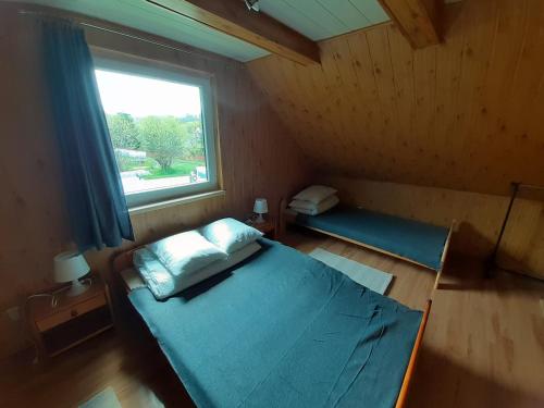 a small room with a bed and a window at Siedlisko Bieszczadzkie 3 in Lutowiska