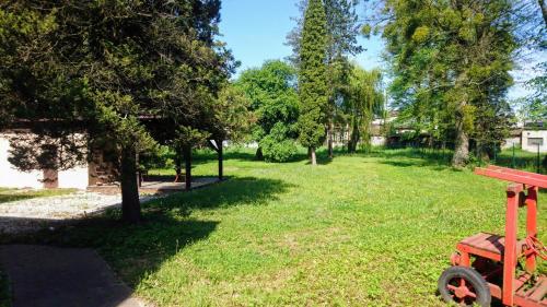 a park with a red bench in the grass at Hotel Antler in Studénka