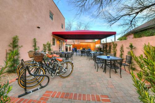 two bikes parked outside of a restaurant with tables and chairs at Armory Park Inn in Tucson