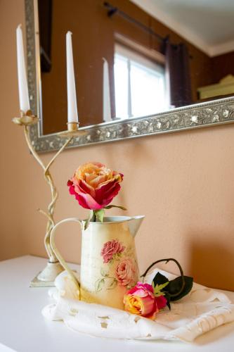 a vase with a flower in it on a table at Rooms Herman in Pivka