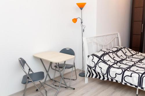 a bedroom with a bed and a table and chairs at Palas Studios in Iaşi