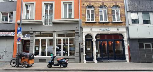 two scooters parked on a street in front of a store at MAISON MARSIL - Boutique Hotel Köln in Cologne