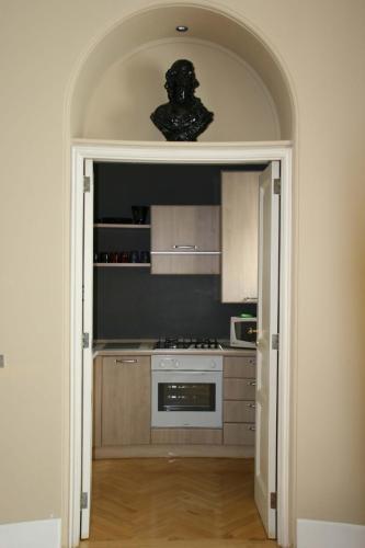 a kitchen with an open door to a kitchen with a stove at Casa Rubinacci in Naples