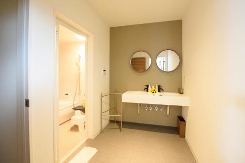 a bathroom with a sink and a mirror at Le.Blanche in Minamiawaji