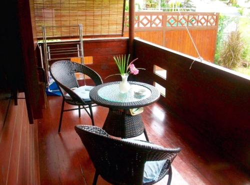 a balcony with a table and chairs and a window at Charming House in Albion with Shared Pool in Albion