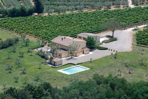 an aerial view of a house with a swimming pool in a field at Villa Pian De Noci - Tenuta del Palagio in Mercatale Val Di Pesa