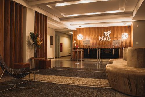 a lobby with a marmite sign on a wooden wall at Mara Turismo Hotel in Catalão