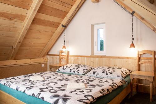 a bedroom with a bed in a attic at Penzion Medvídek Tanvald in Tanvald