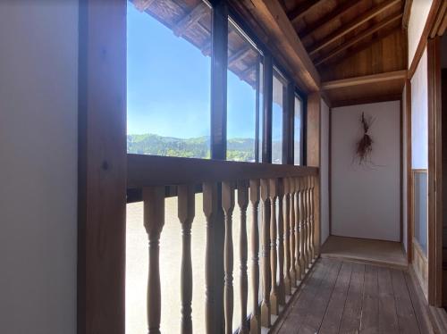 a balcony with a large window in a house at KOME HOME in Tokamachi