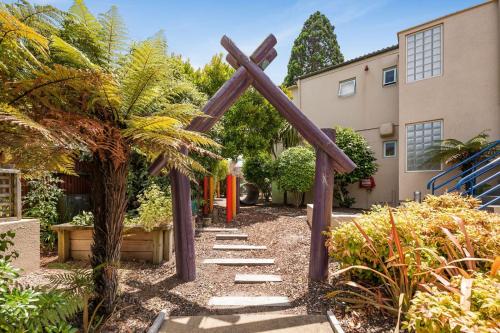 a wooden cross in the middle of a garden at The Village Resort in Taupo