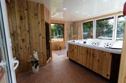 a large bathroom with a large tub and wooden walls at Mała Wenecja - pokoje gościnne in Nowe Worowo