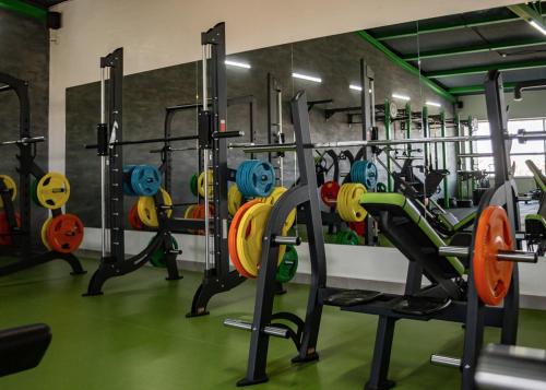 a gym with a bunch of tread machines in it at Hotel DoZari in Korostyshiv