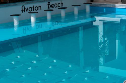 a swimming pool with a reflection in the water at Avaton Luxury Resort and Spa Access the Enigma - Adults Only & Kids 14 Plus- in Asprovalta