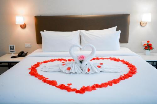 a bed with a heart made out of roses at Summer Tree Hotel in Bangna