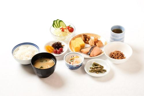 a table topped with different types of food at Marroad Inn Tokyo in Fuchu