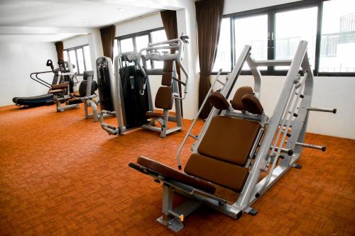 a gym with several tread machines in a room at Summer Tree Hotel in Bangna